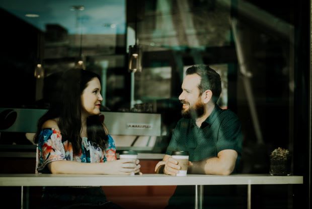 a couple talking at a coffee shop