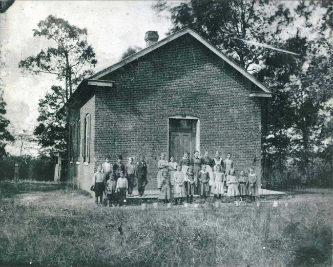 Schoolhouse with students in the 1890s