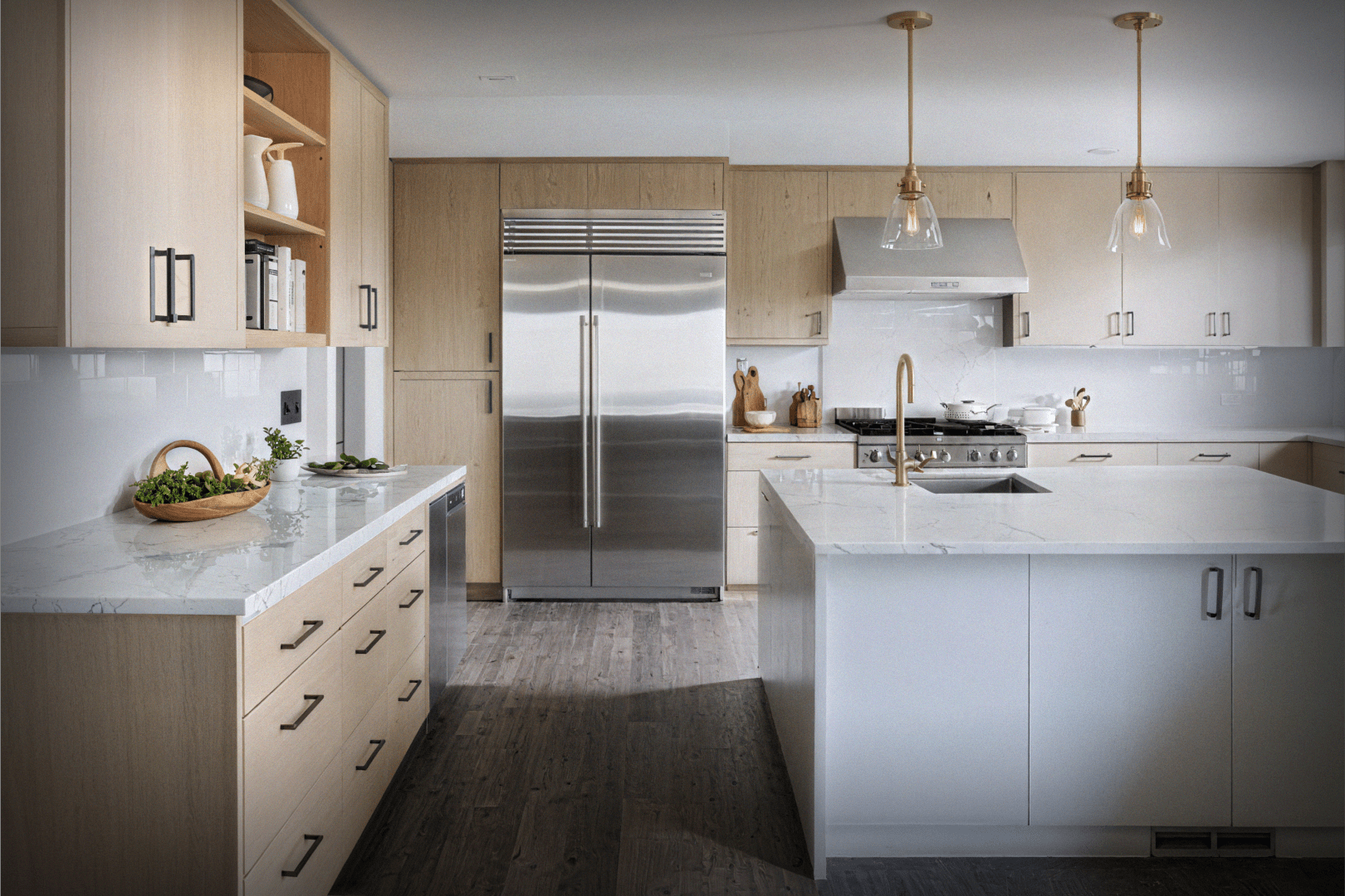 Light Scandinavian-style kitchen with large stainless refrigerator, pendant lighting, and white cabinetry