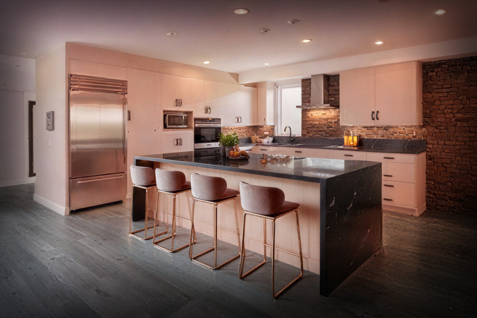Modern kitchen with warm ambient lighting, large island, stainless-steel appliances, and wood cabinetry