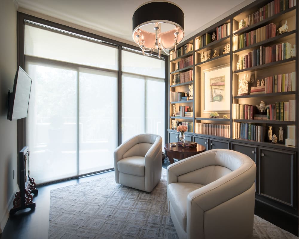 Bright open-plan condo living room with floor-to-ceiling windows and city views