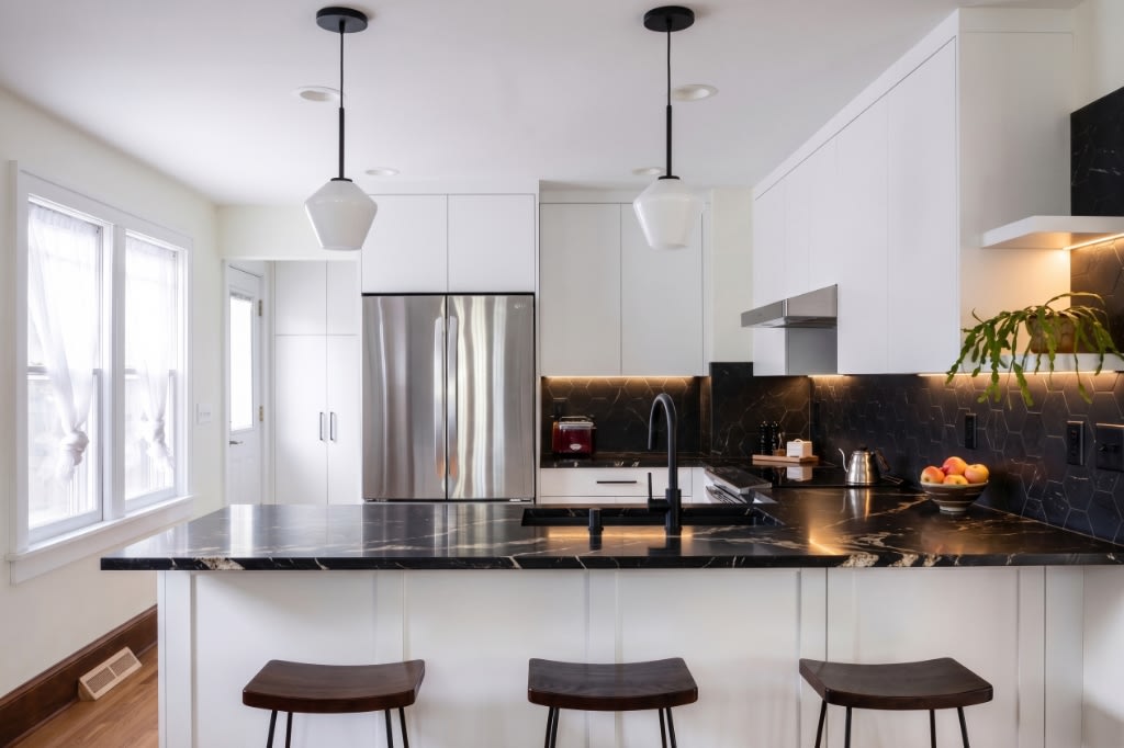Monochrome & Nero Marquina — high contrast modern kitchen with white flat-panel cabinetry, black veined marble countertops, and black hex backsplash in Washington DC