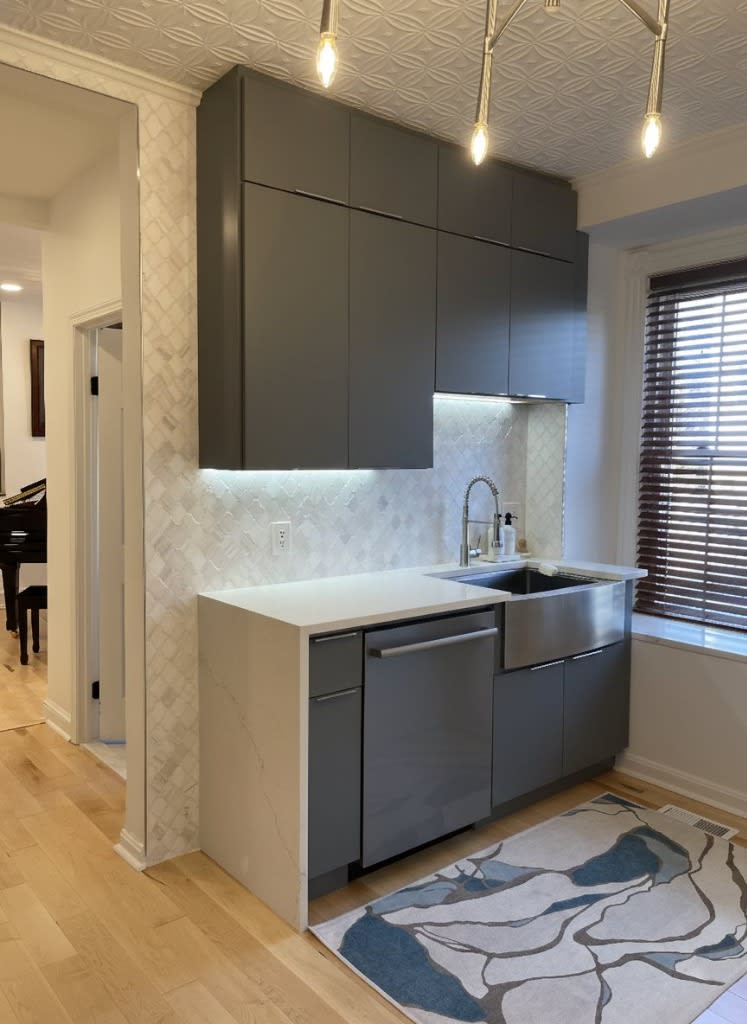Slate & Arabesque Elegance — modern kitchen remodel with slate gray cabinetry, stainless apron sink, and marble arabesque backsplash in Washington DC