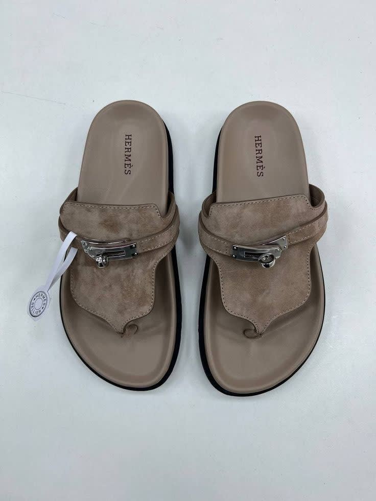A suede thong sandal with silver hardware