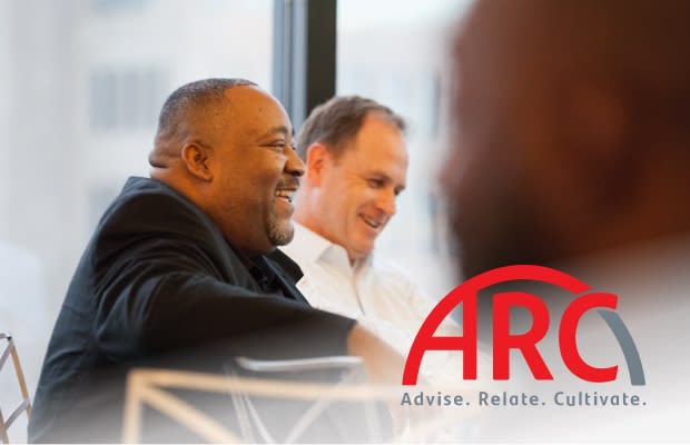 Smiling african american man in a suit sitting at a table