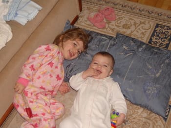 Abby and Rebekah lounging in their pajamas.