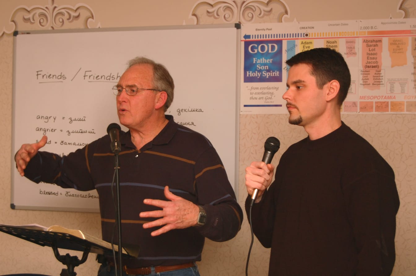 Jessie teaches on the authenticity of the Bible at ABS, while Joshua translates.