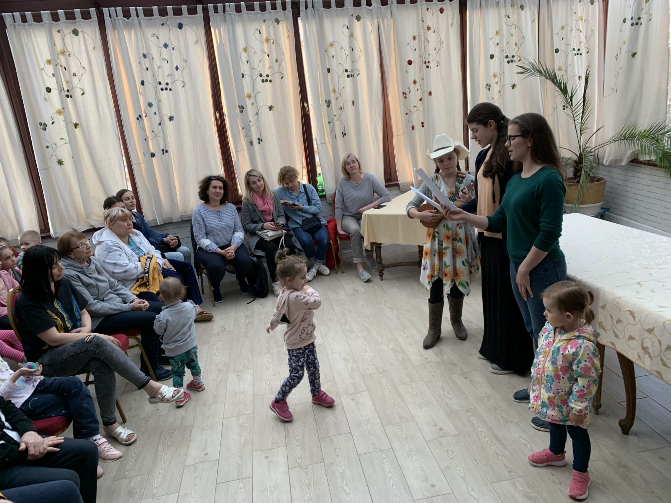 Abigail, Rebekah, and Hosanna sing a Ukrainian song at the second of two hotels where we did outreach concerts for Ukrainians in Poland.