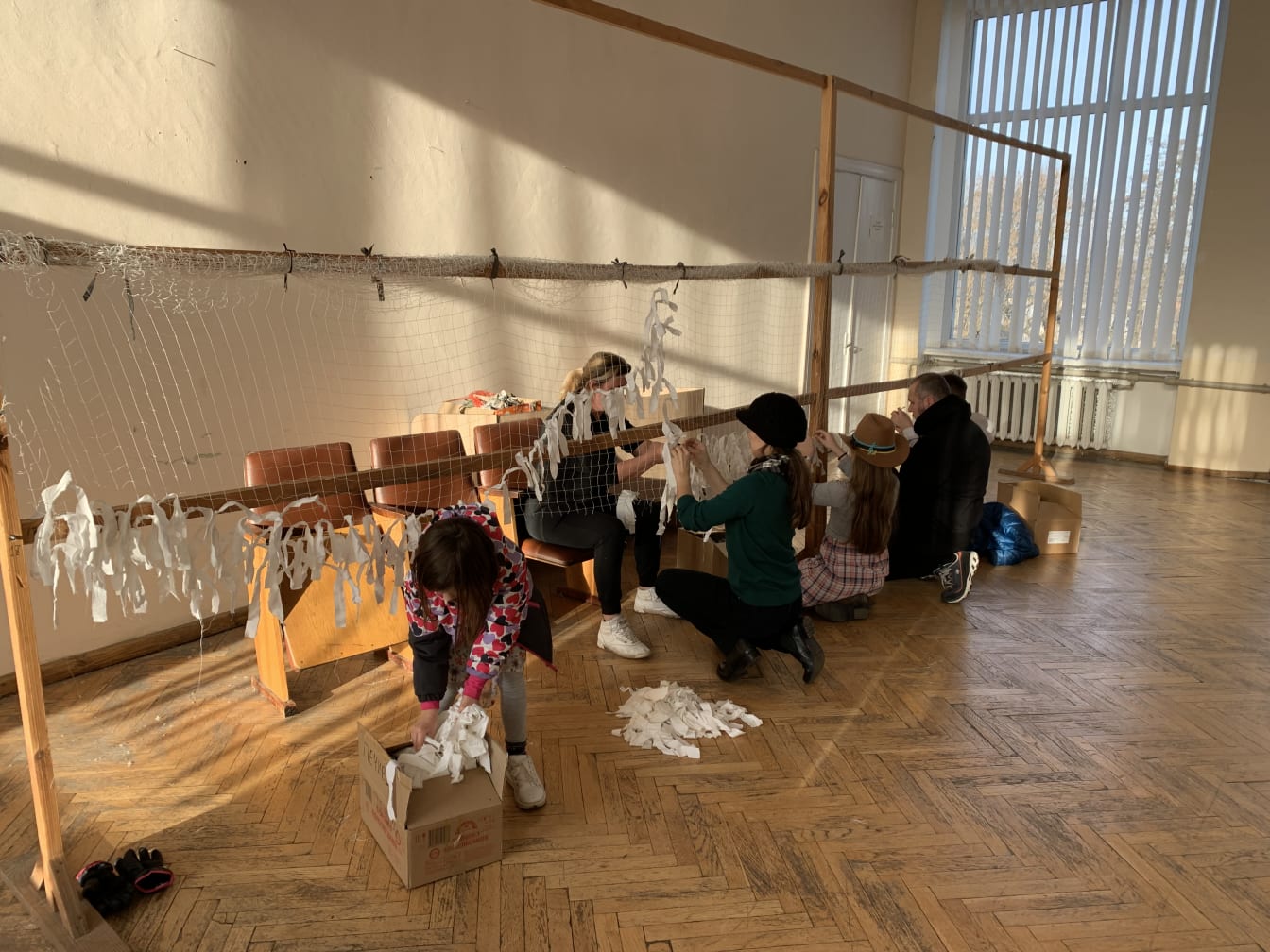 As we previously reported, the kids got to help weave camo netting with the volunteers in Radekhiv. They used white since this was still winter time.