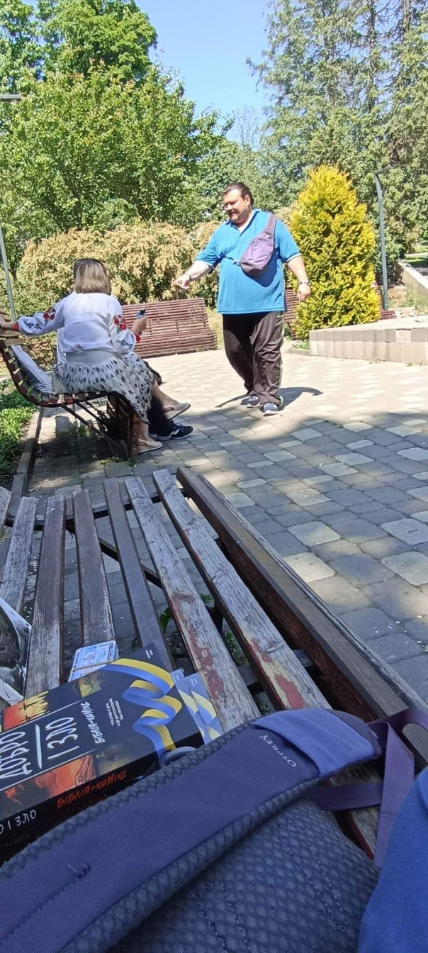 Andrii Pukavskyi hands out tracts and Good and Evil’s at a park.