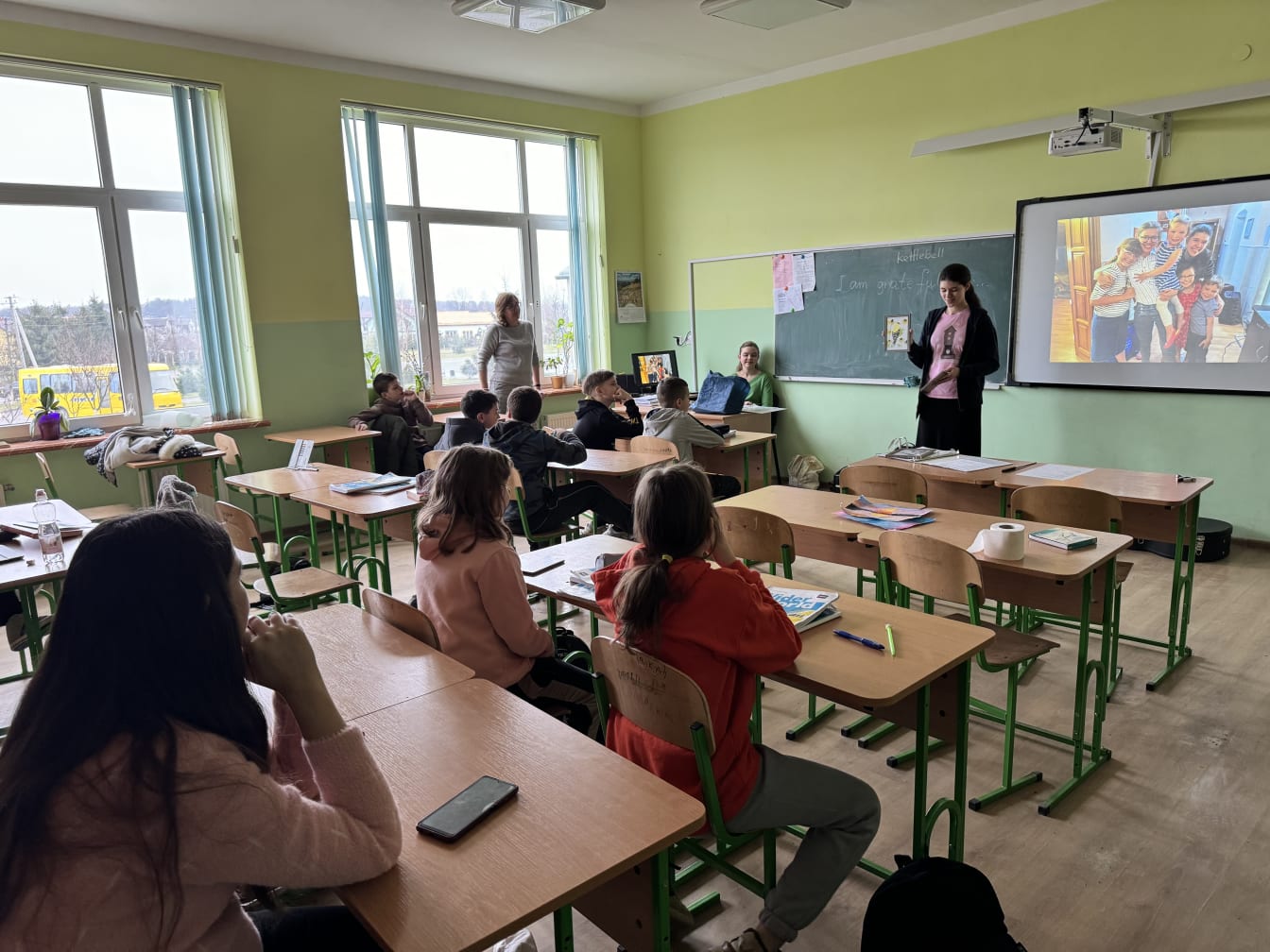 Our family was recently invited to speak at a local school. In this photo, Rebekah shares with the kids some favorite books she enjoys reading.