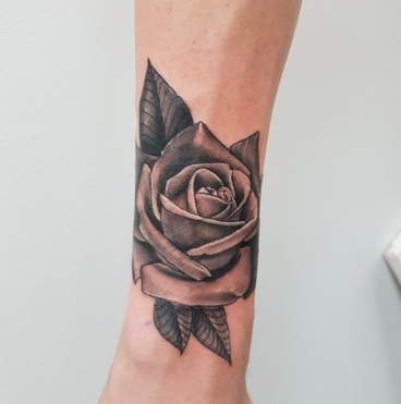 Black rose arm tattoo