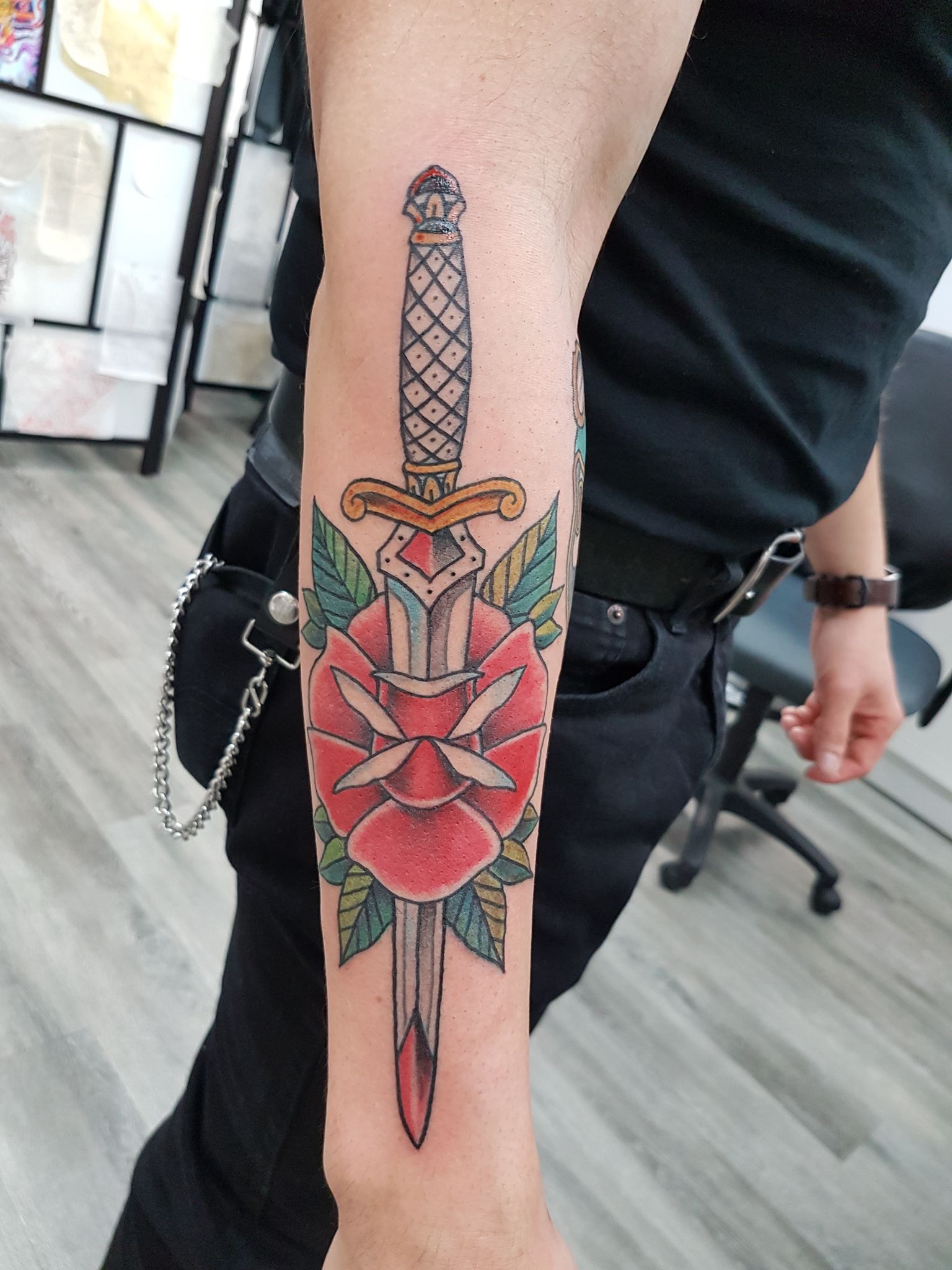 Blade and rose arm tattoo in color