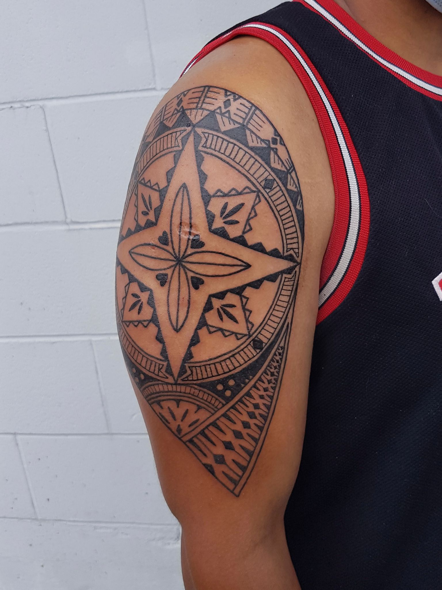 Black and white fijian arm tattoo