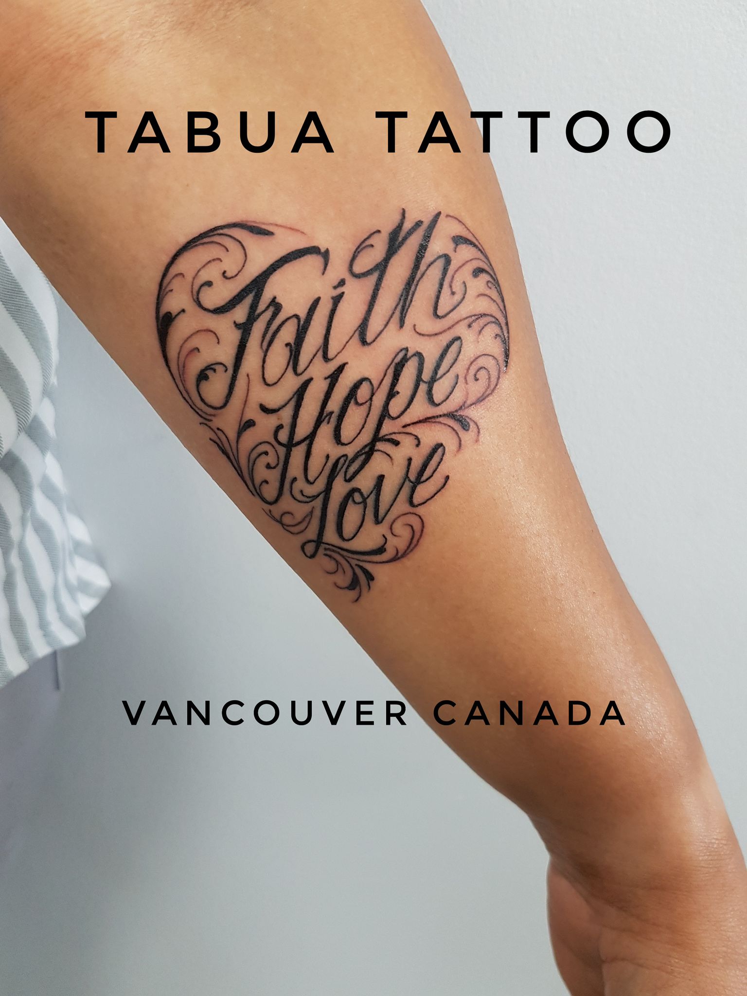 Black and white upper arm script tattoo