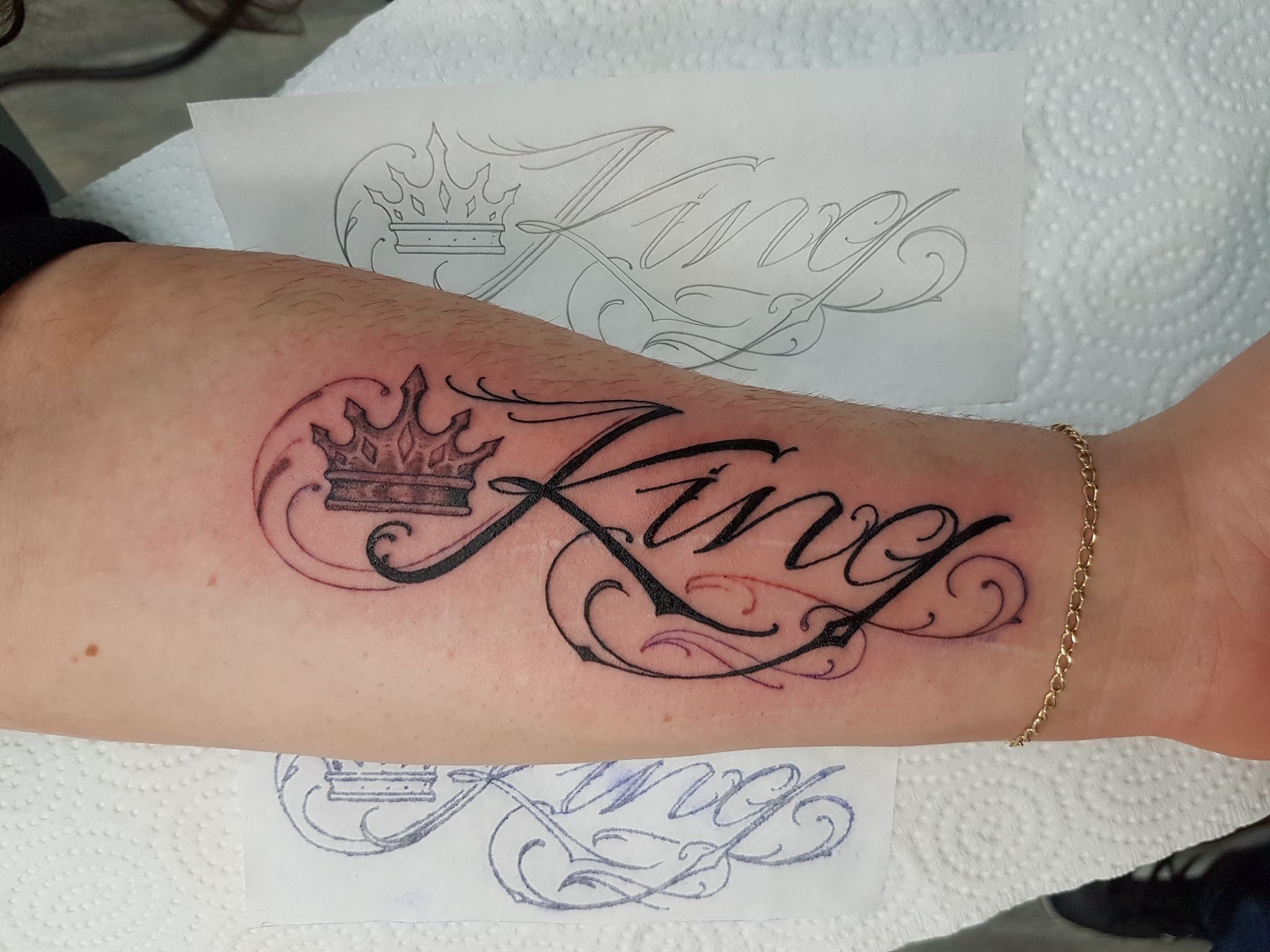 Script arm tattoo