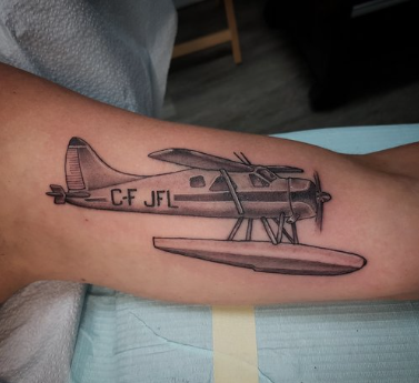 Black plane arm tattoo