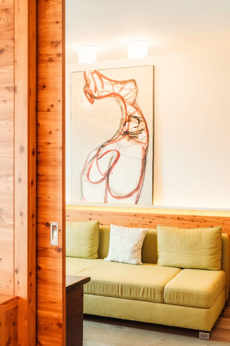 A cozy room in Glemmtalerhof with a modern painting and a comfortable couch.