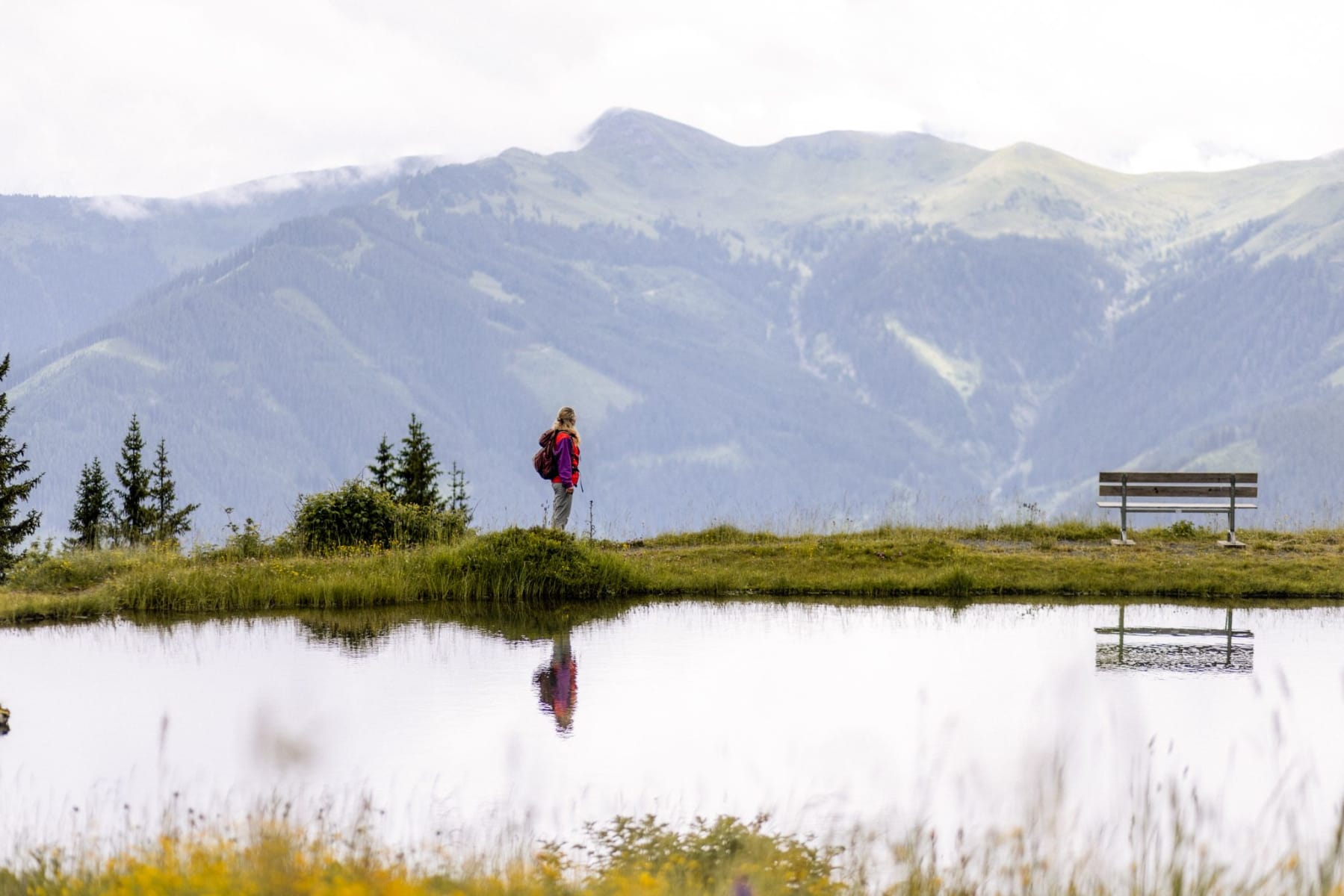 Eine Wanderin genießt die Aussicht im Glemmtal bei Hinterglemm.