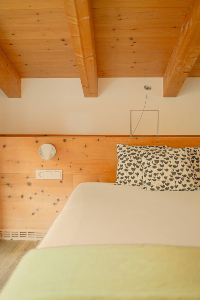 A cozy room at Glemmtalerhof in Hinterglemm with wooden details and an inviting bed.