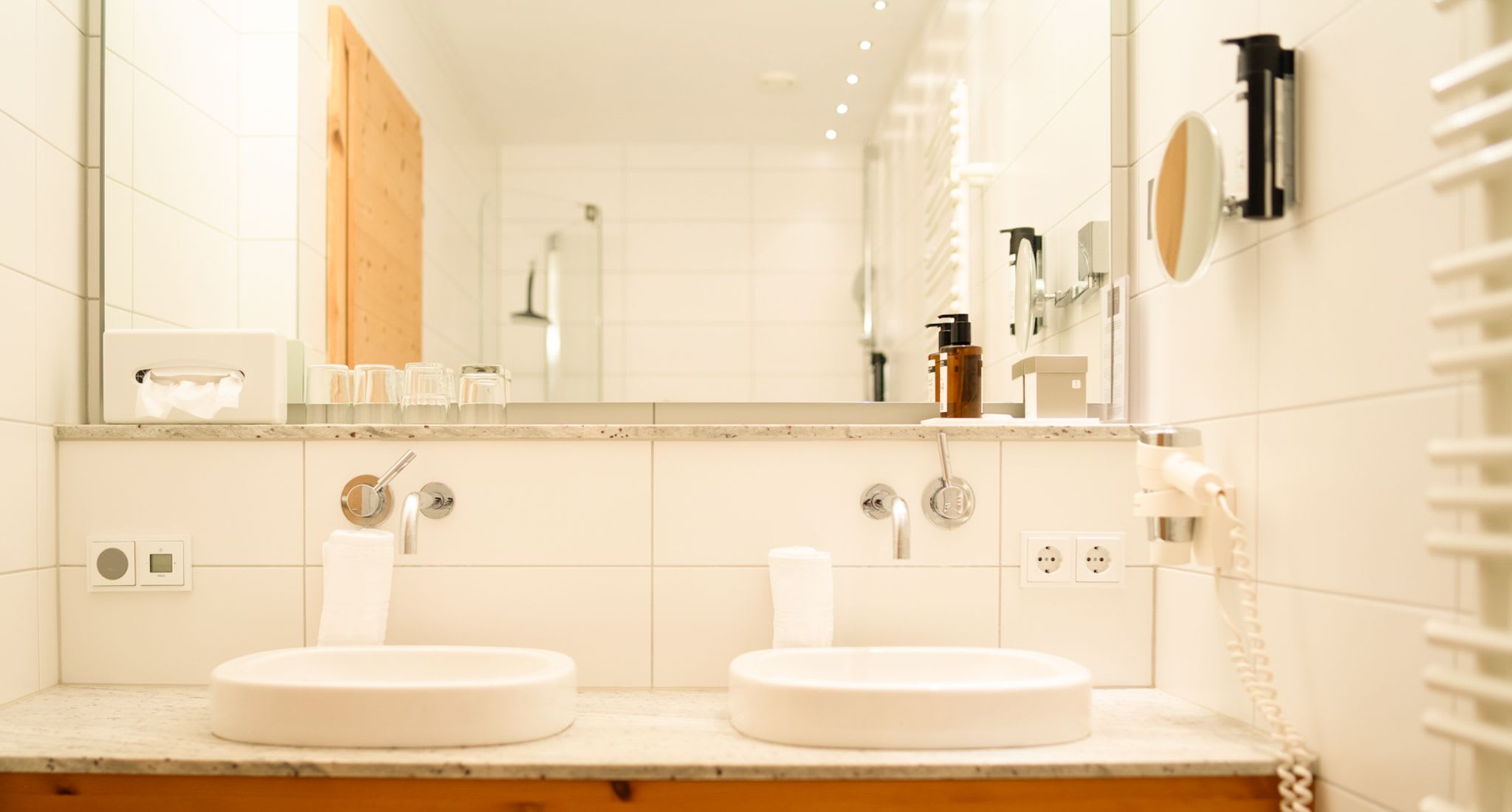Modern bathroom with double sink at Glemmtalerhof in Hinterglemm.