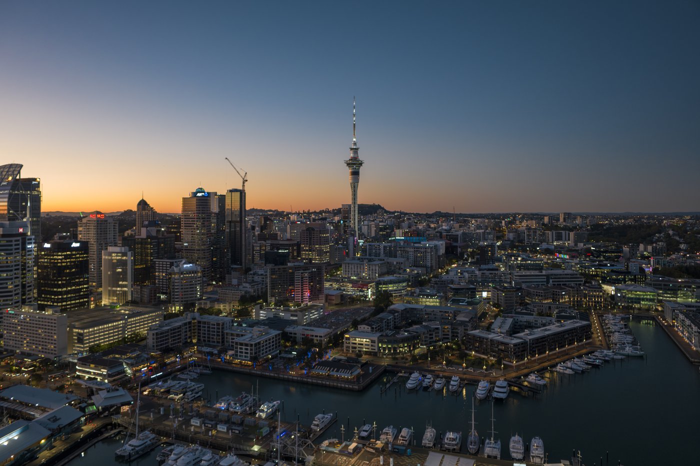 Auckland city skyline at dusk, Sky Tower and Viaduct Harbour