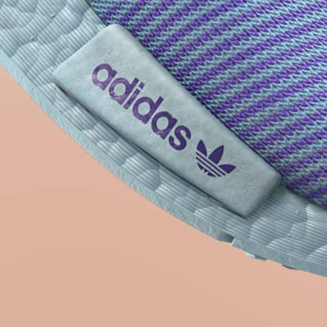 Adidas Prime Knit close up of the purple and litght blue mesh and light blue outsole with background peach