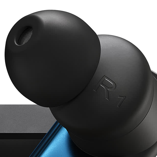 Close up right side Status wireless earbud in black and blue