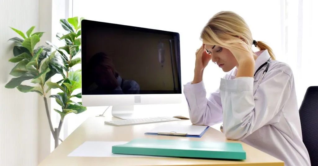 Physician stressed at her desk