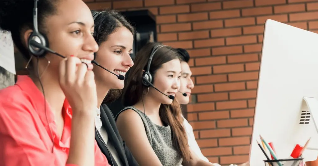 Group of call center reps talking to patient