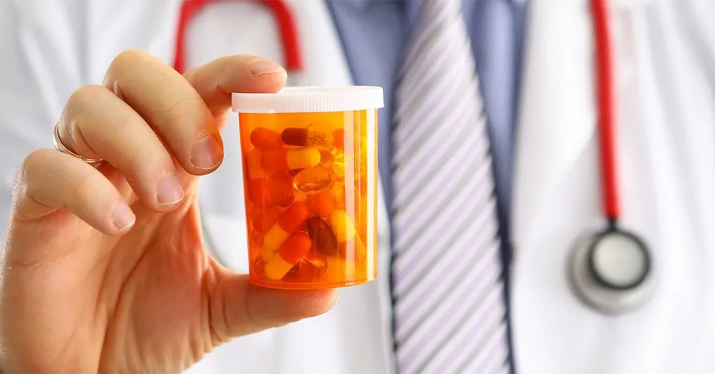 Doctor holding medication for patient