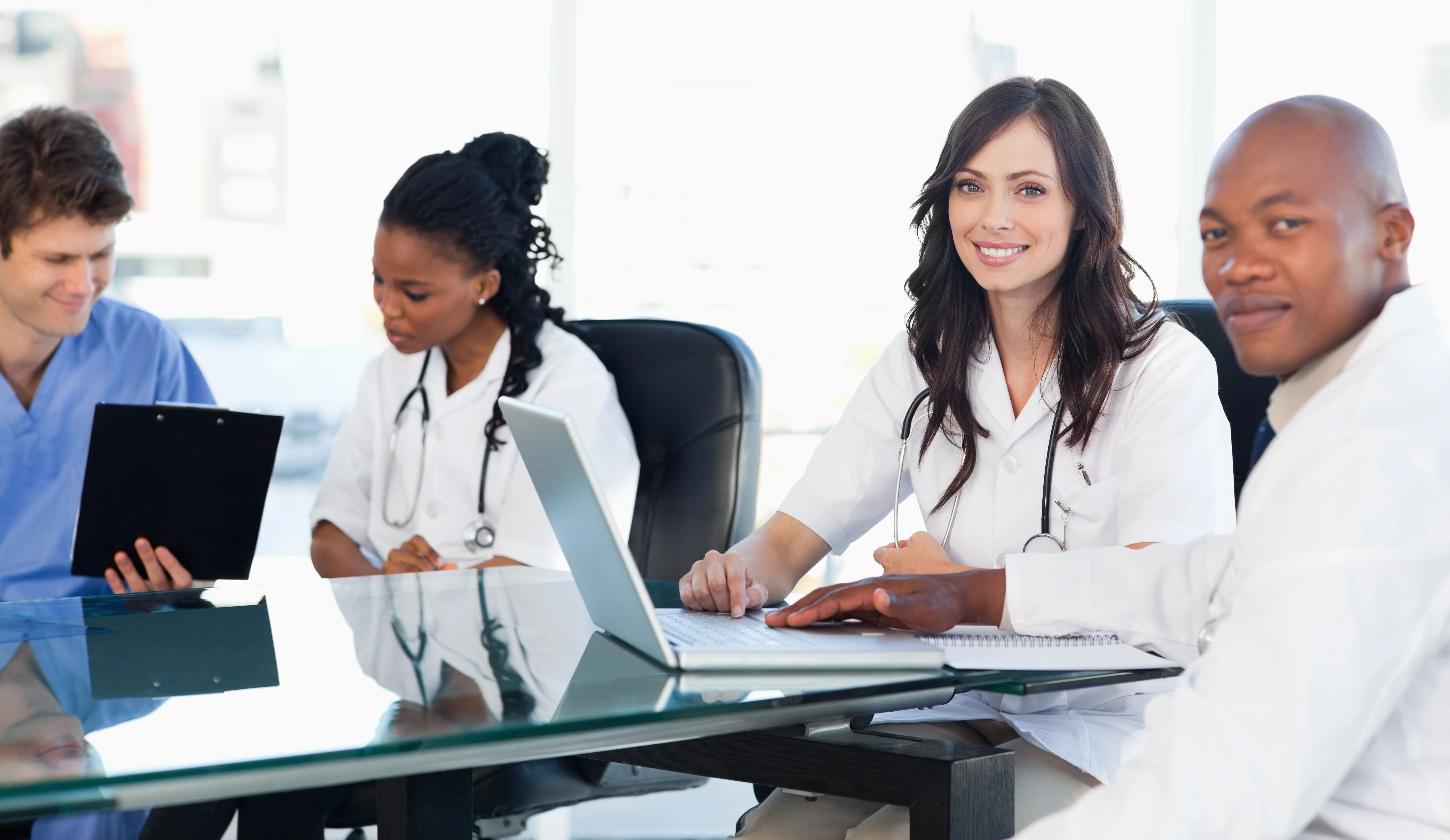 Members of a medical team working on a laptop