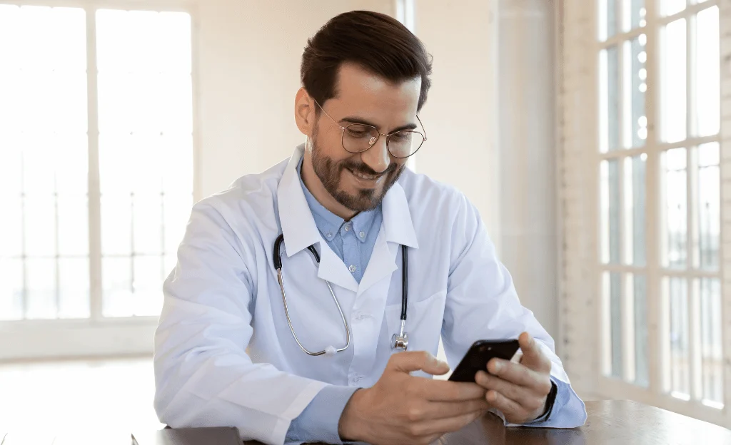 doctor looking at mobile screen