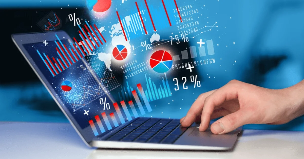 typing on modern laptop with graph