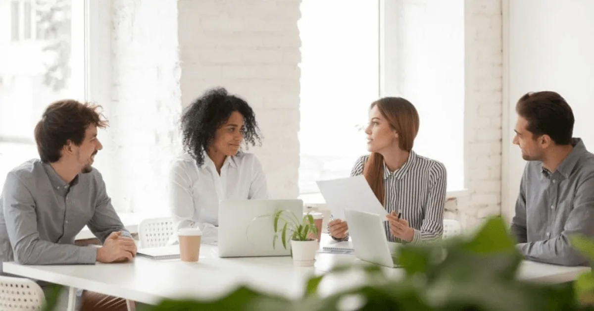 Employees discussing work at office