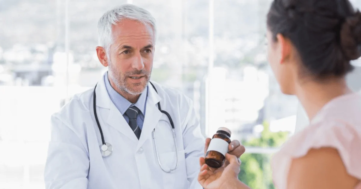 doctor giving medicine to patient