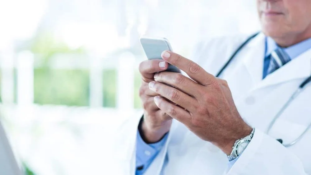 Doctor looking at mobile