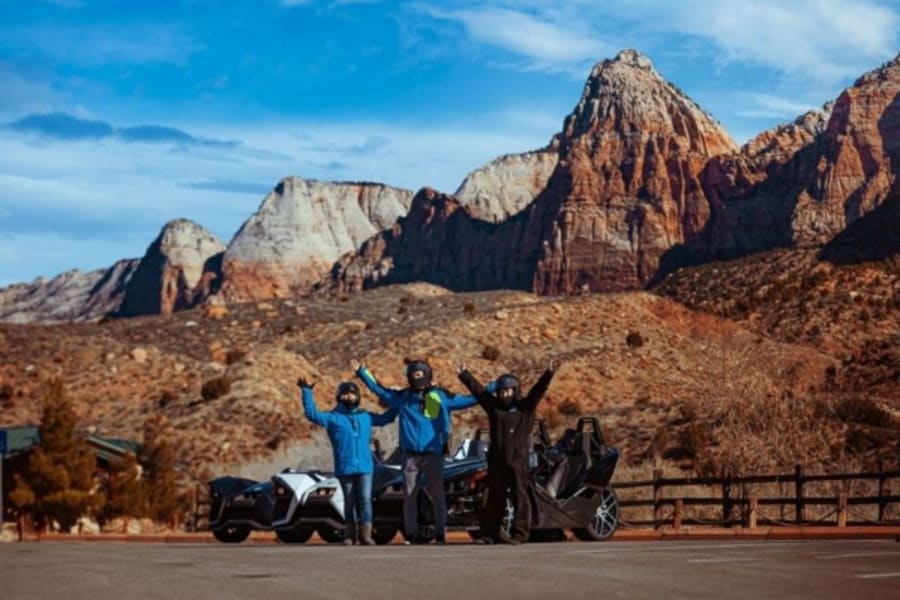 Three drivers standing outside Polaris Slingshot in Utah