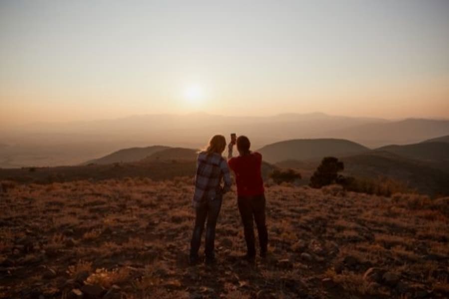 Two people taking selfie in Utah at sunset