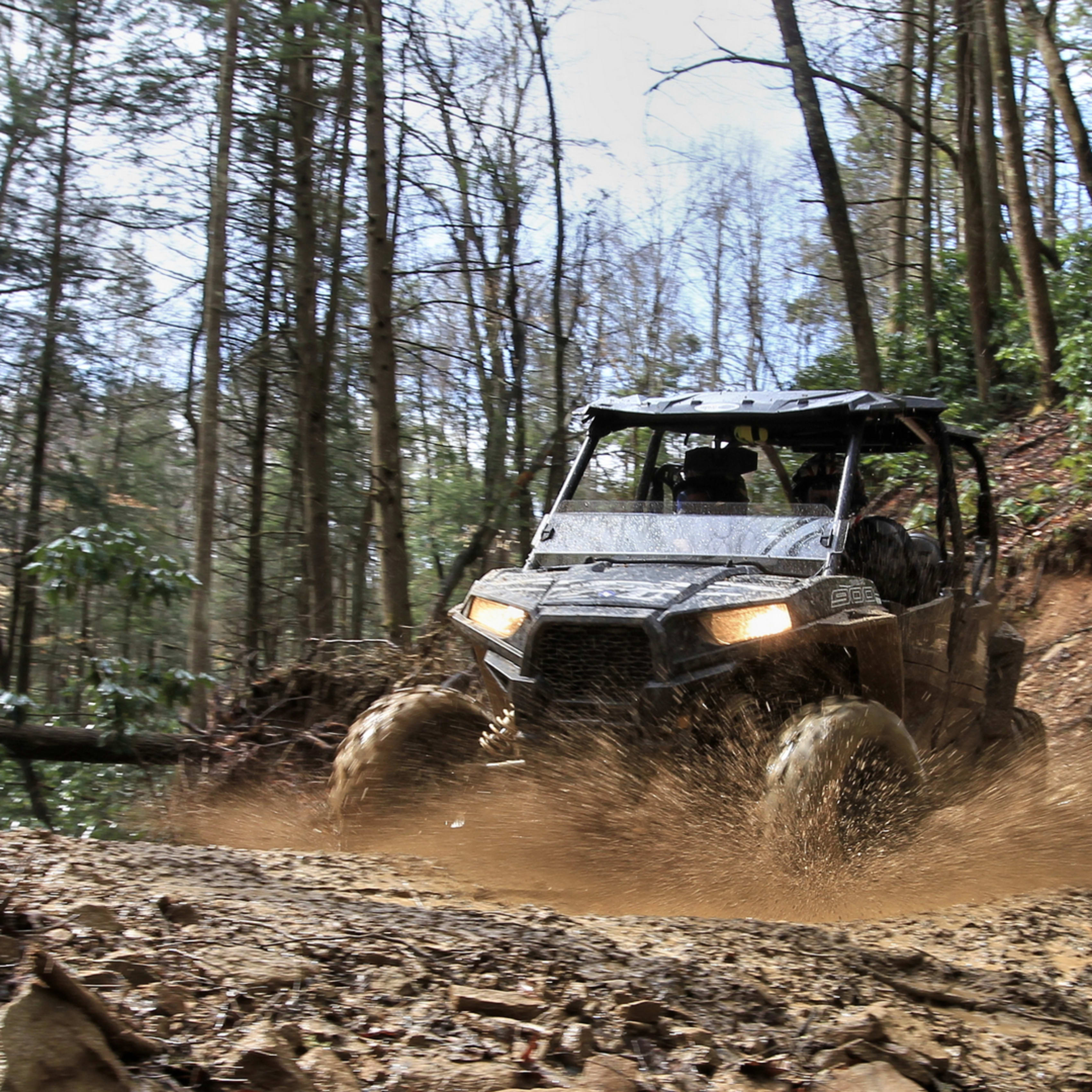 Polaris RZR driving through mud