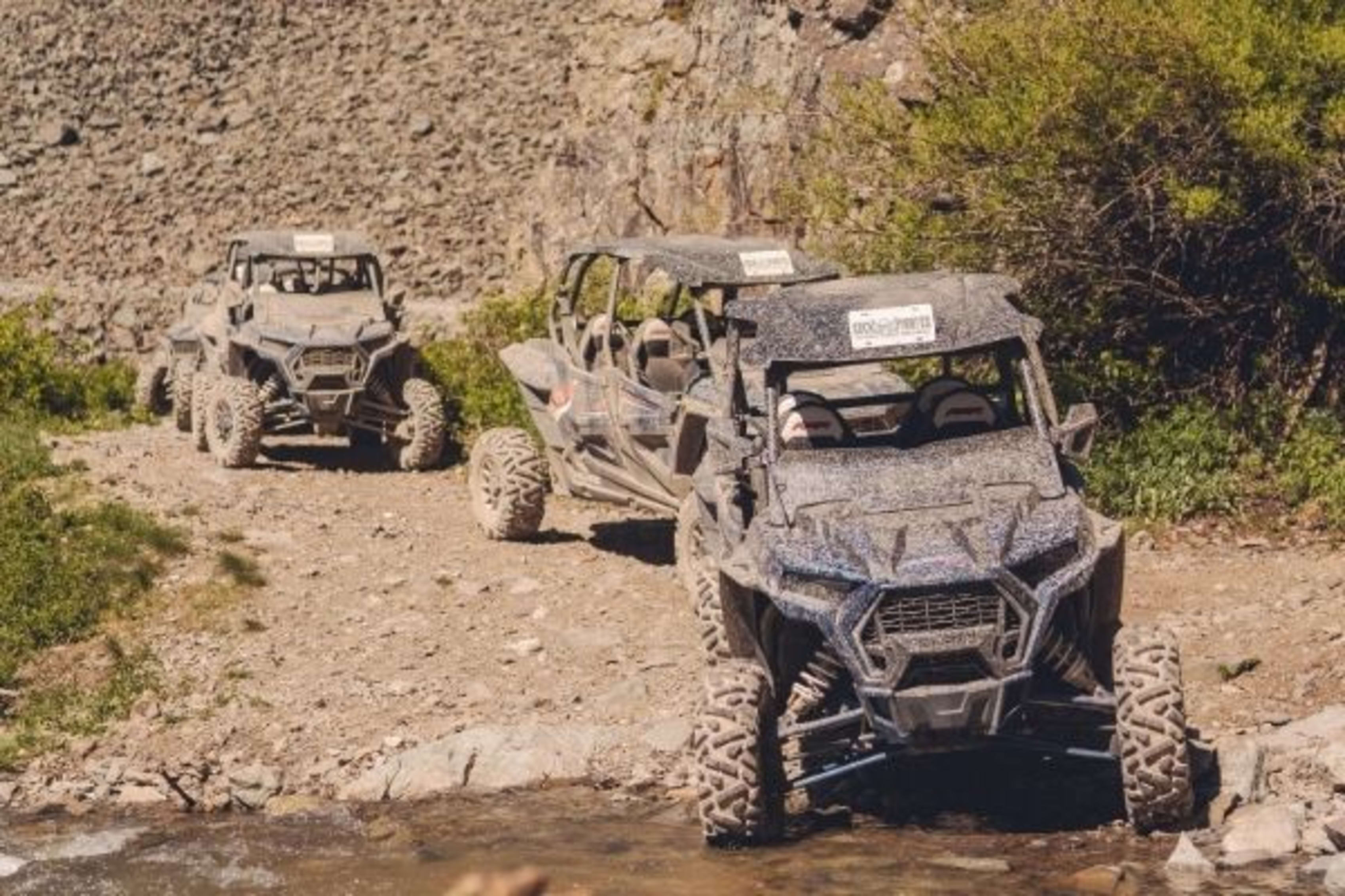 Polaris RZRs crossing creek