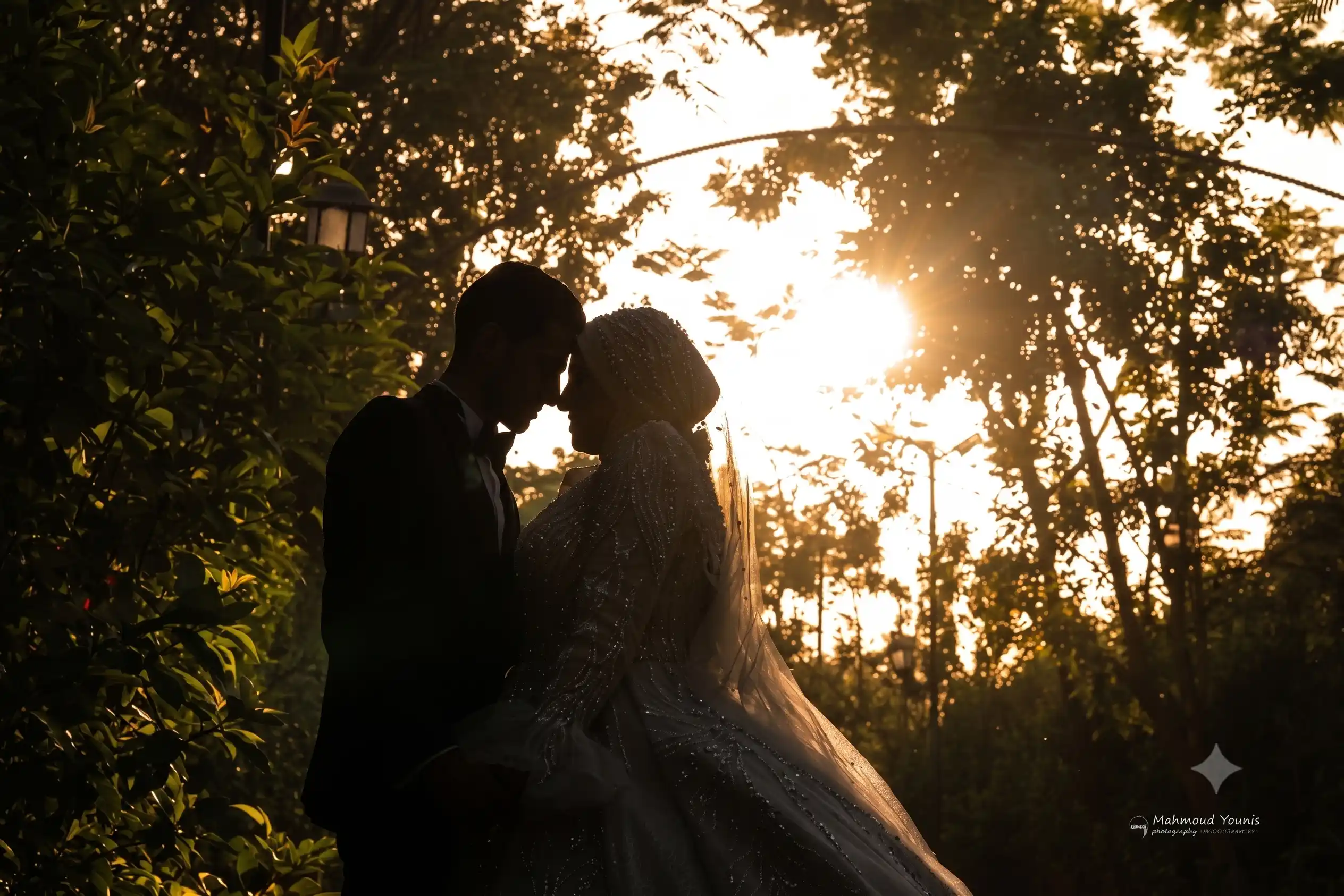 A bride and groom on a breathtaking cliffside overlooking a misty ocean, captured in an editorial luxe style