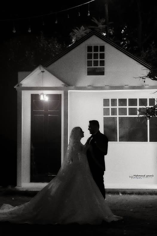 Architectural detail of a wedding venue with white marble columns against a soft grey sky