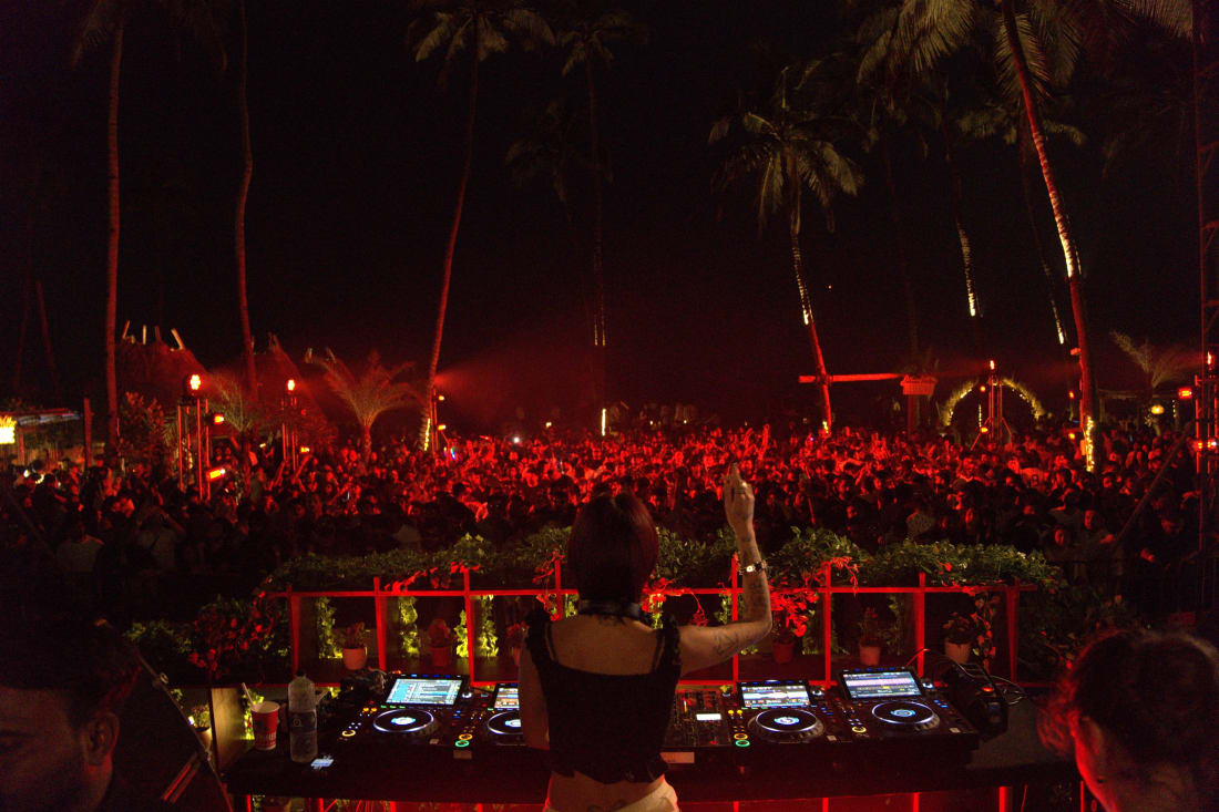 A DJ facing a packed night crowd at an Indian music festival powered by AtomX cashless payments and access control