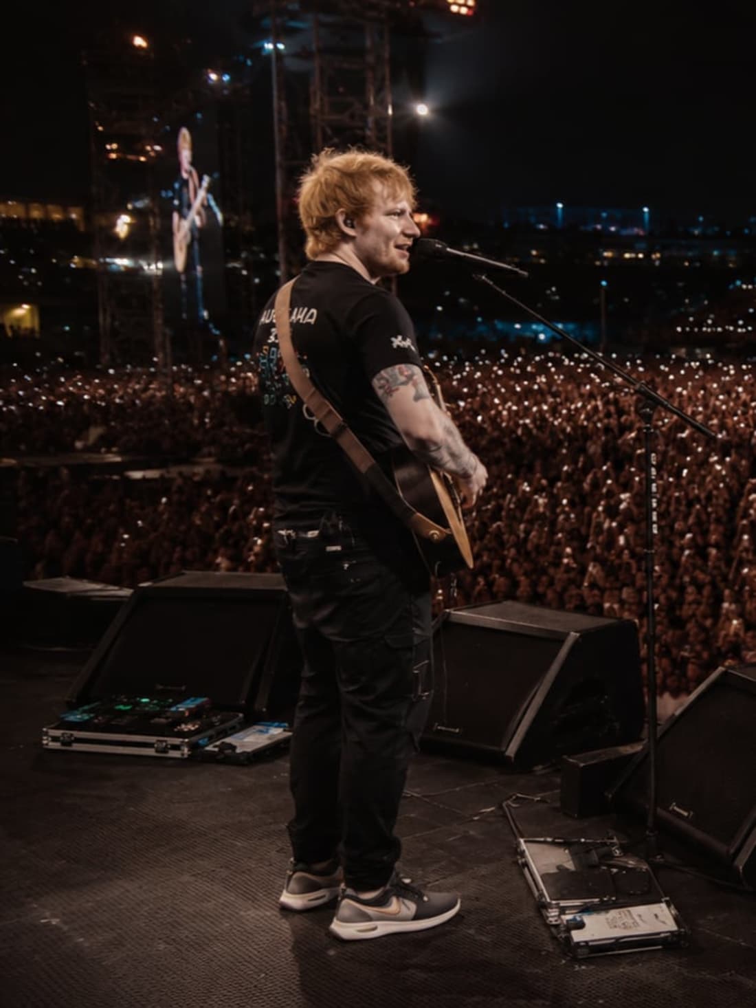 Artist performing to a stadium crowd of tens of thousands at a BookMyShow Live event in India