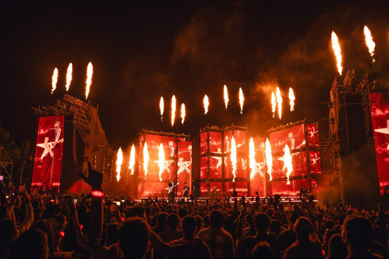 Stadium-scale live concert stage with pyrotechnics and a full crowd, powered by AtomX event access control and cashless payments