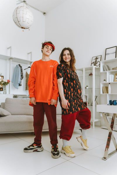 two cool teens standing in a white teen room