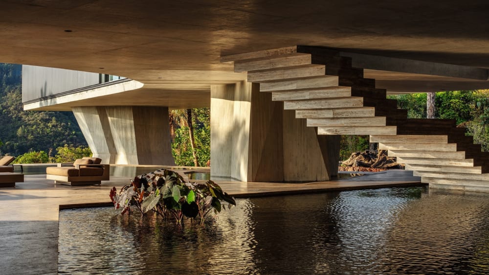 Casa Xingu — retained stone terrace walls — Tetro Arquitetura