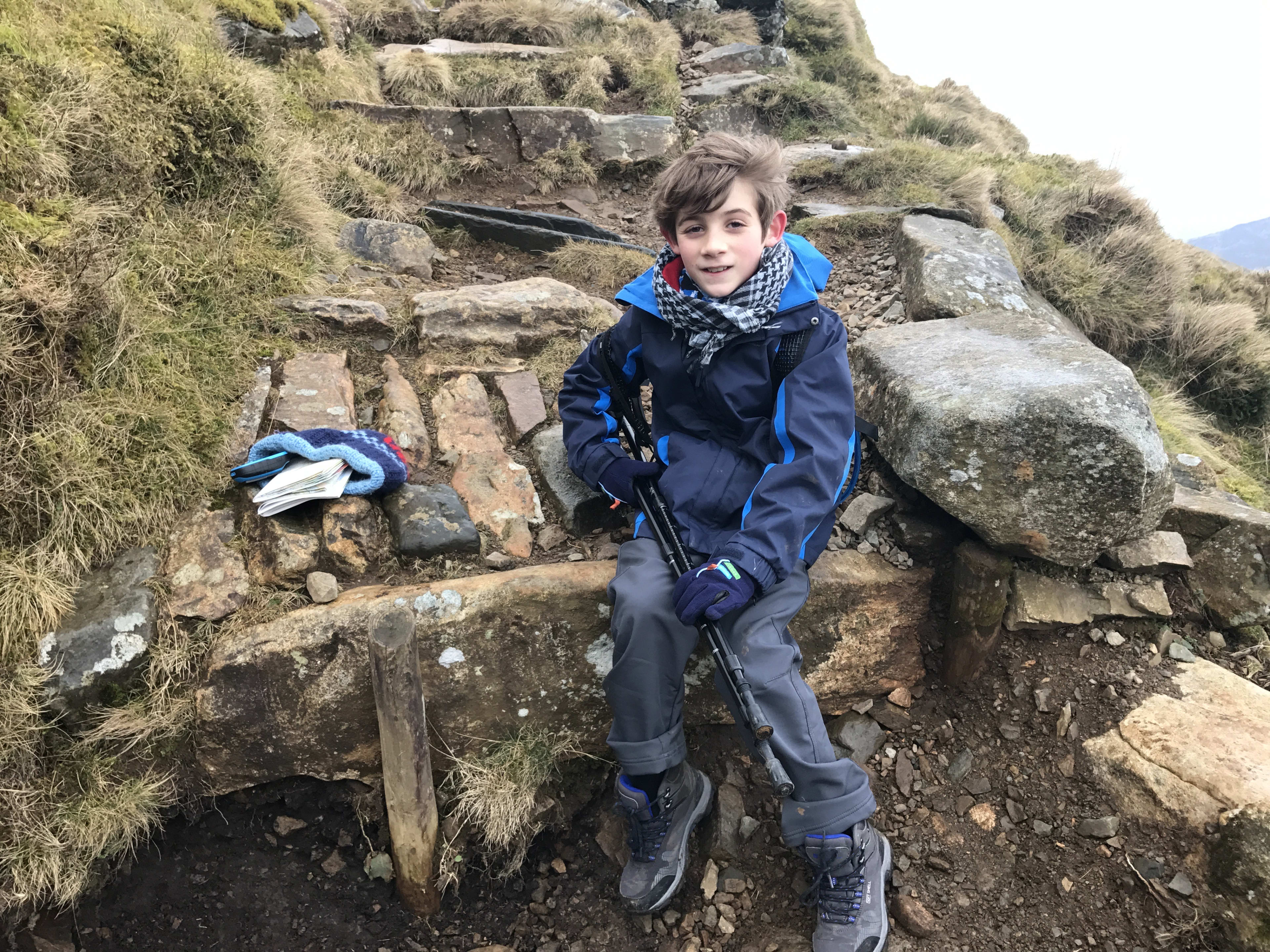 Charlie mountain hiking with walking poles, Highland landscape