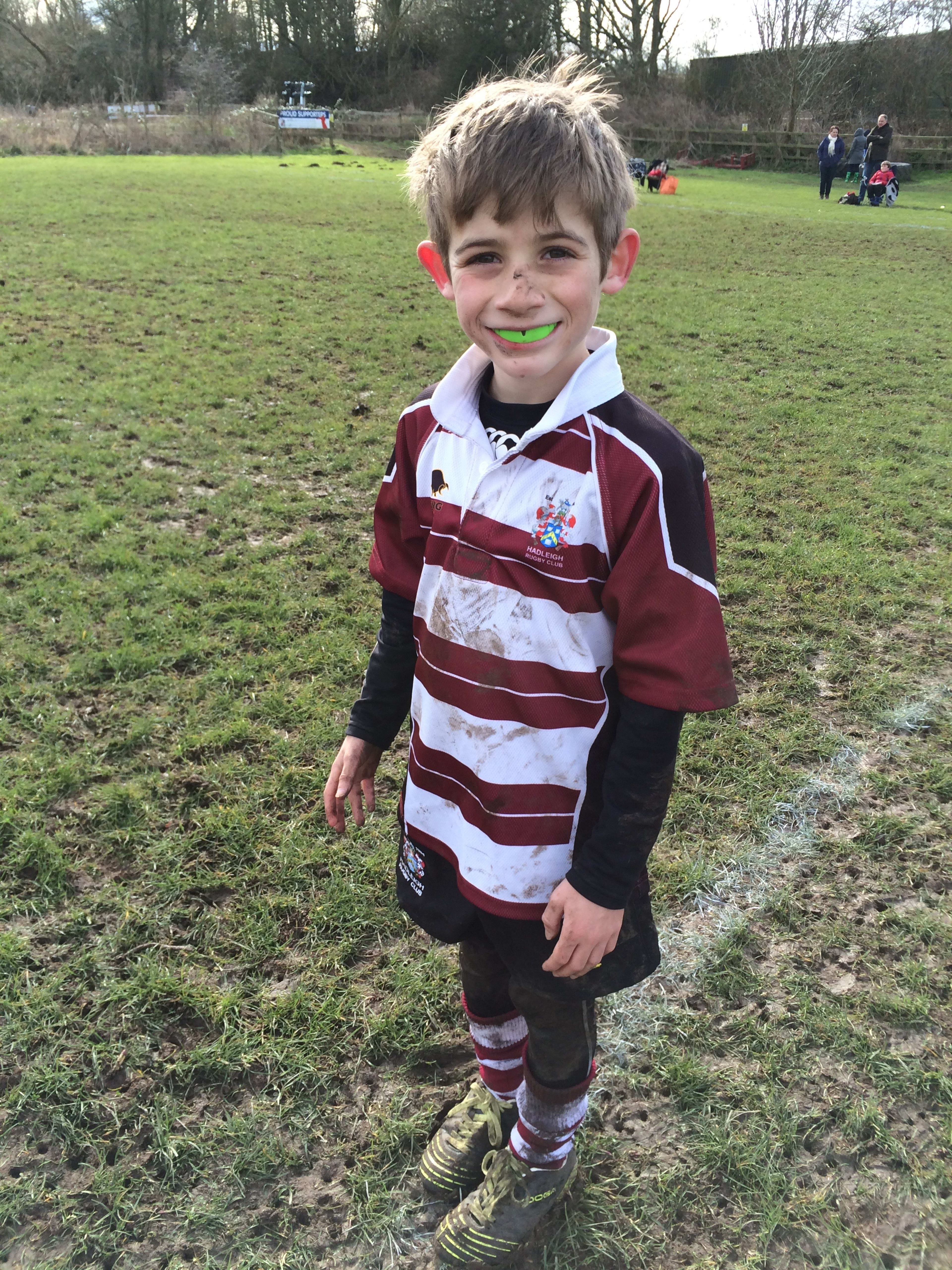 Muddy rugby grin